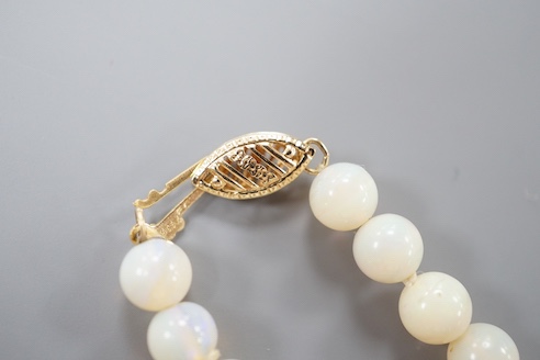 A modern single strand white opal bead necklace, with 585 yellow metal clasp, 44cm.